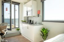 Room with chair and desk at The Bridge Phase II