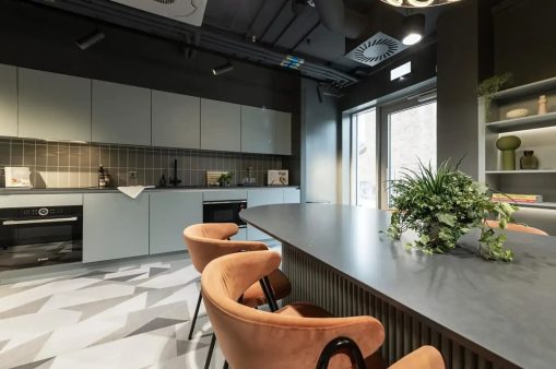 Room with kitchen and chair at Huxley Studios